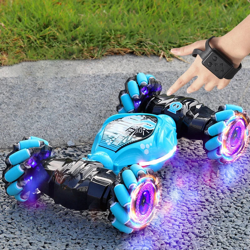 Toy car with glowing wheels on a pavement surface, controlled by a remote.