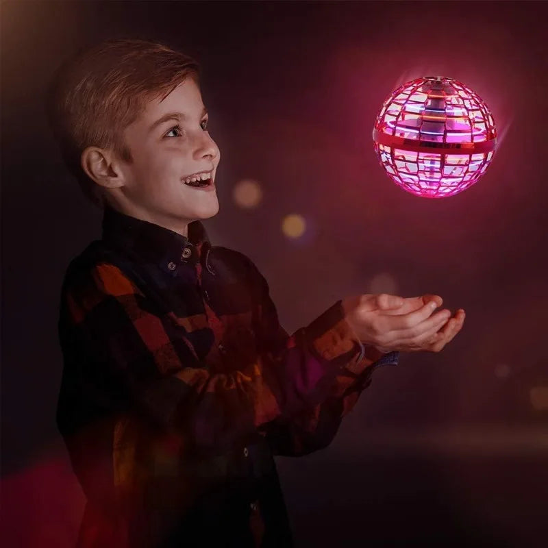 Child holding a disco ball with a dark background